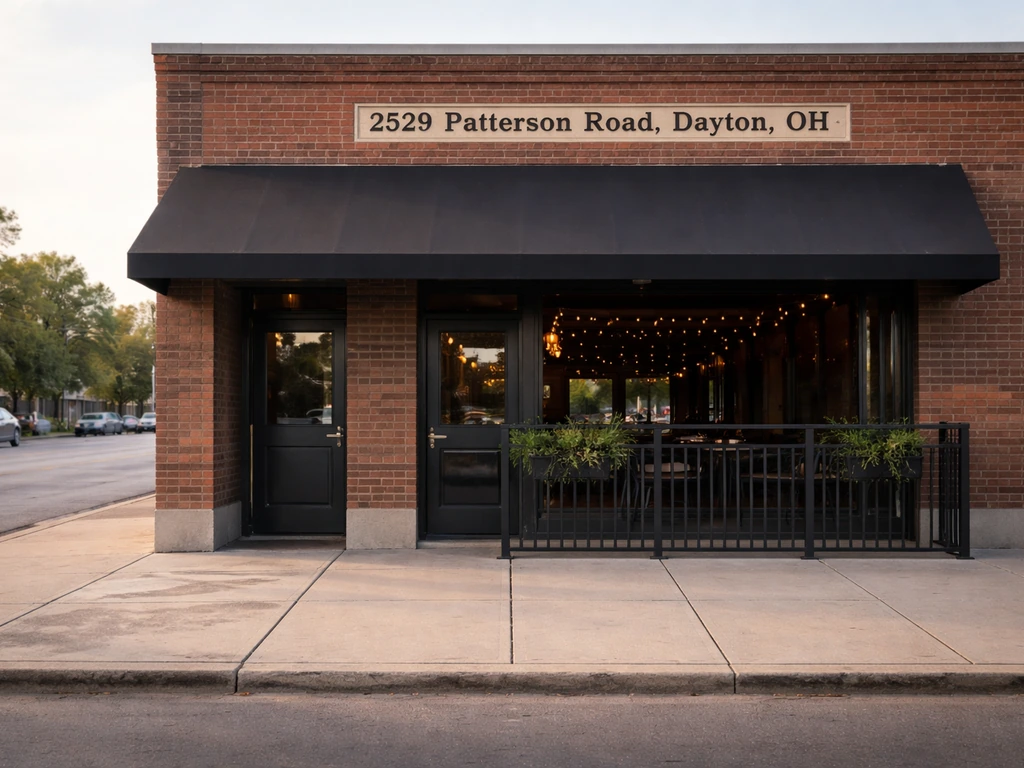 Street-level view of a local bar exterior with a visible address area on the building facade in Dayton