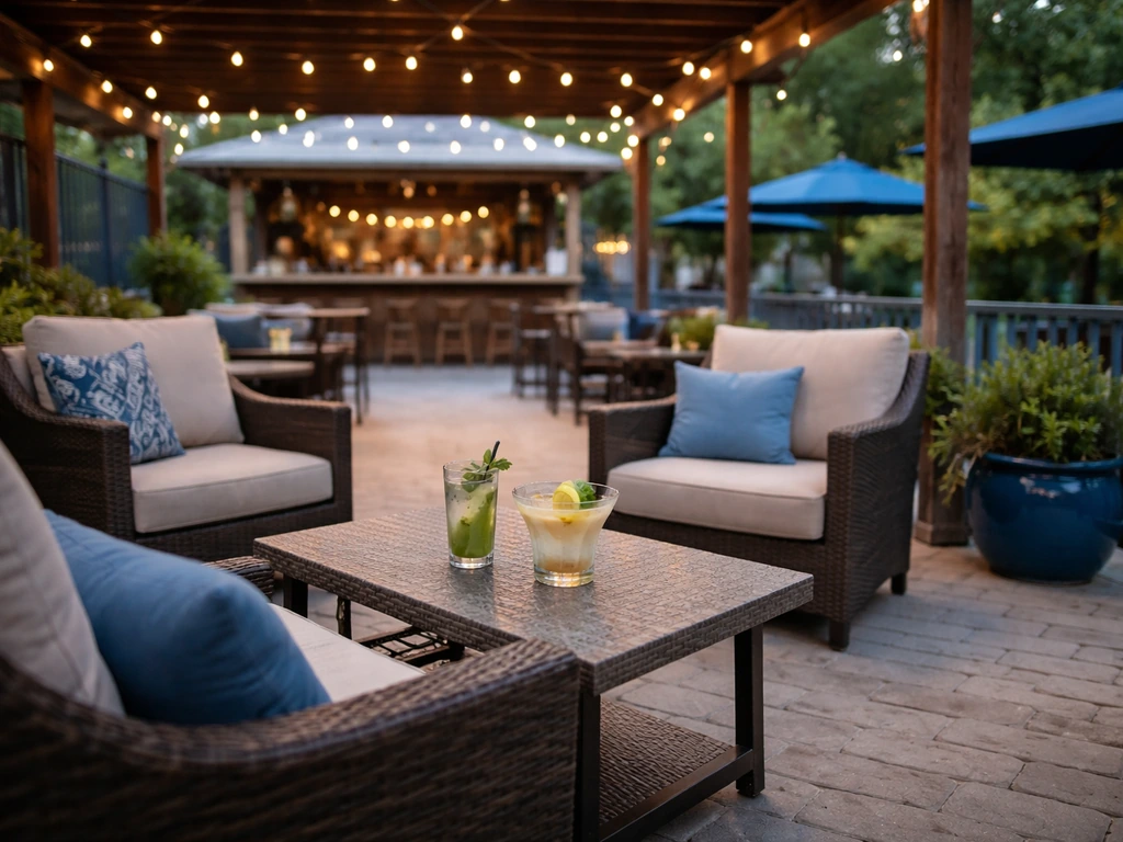 Covered patio with blue accents, outdoor seating, and a bar setup with drinks in the background.