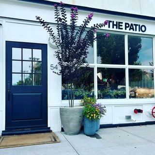 Exterior of The Patio at 54 Main in Westhampton Beach with the storefront and entrance visible