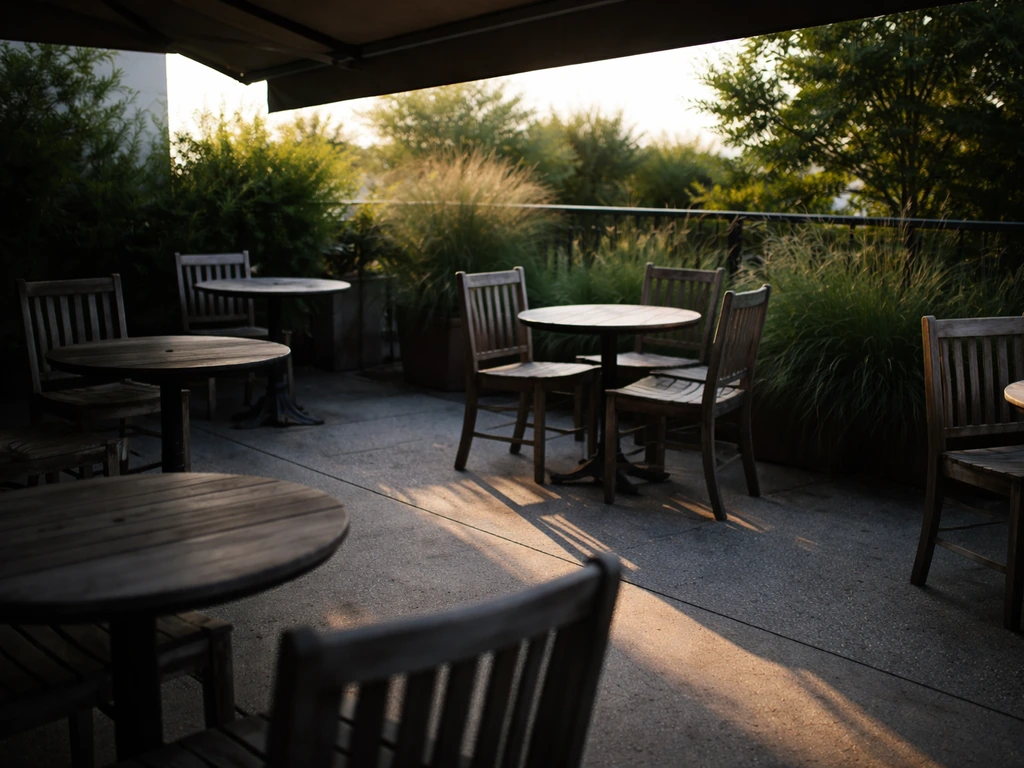Empty oyster bar patio showing clear sun glare and shaded seating zones.
