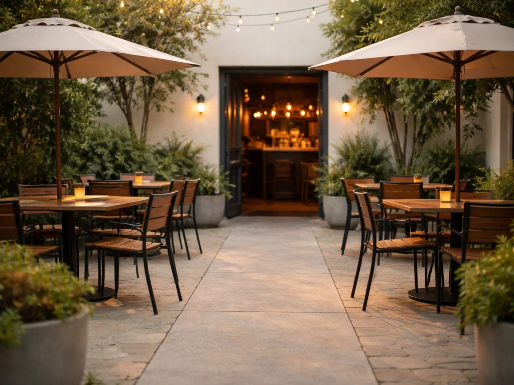 Cozy restaurant patio with outdoor seating and open doorway connecting to an inviting indoor bar area.