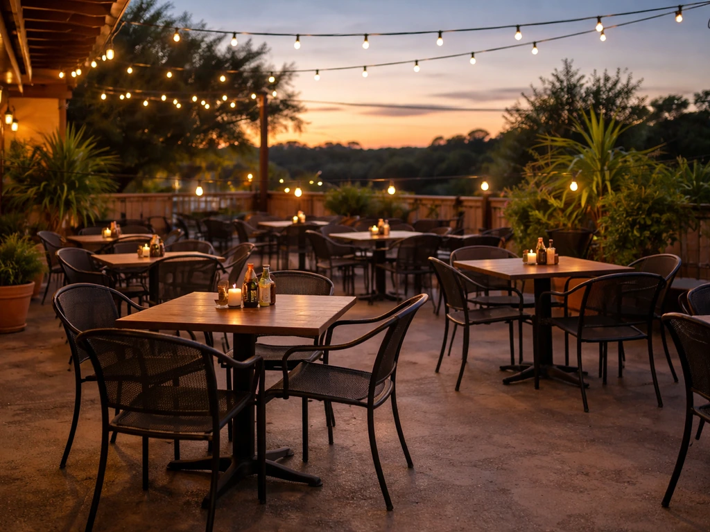 Warm Hill Country sunset over an empty restaurant patio in San Marcos, Texas with string lights aglow.
