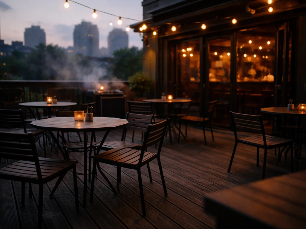 Rooftop patio at dusk with warm lighting, patio seating, and grill smoke for a relaxed vibe