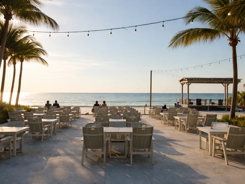 Beachside restaurant patio with rows of outdoor seats facing a clear ocean horizon