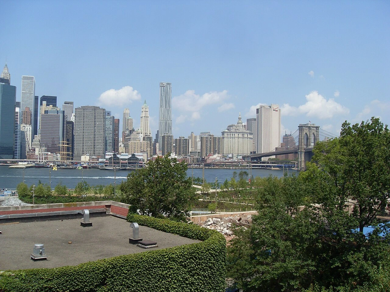 Brooklyn Bridge Park and Manhattan skyline with the Brooklyn Bridge visible in the distance